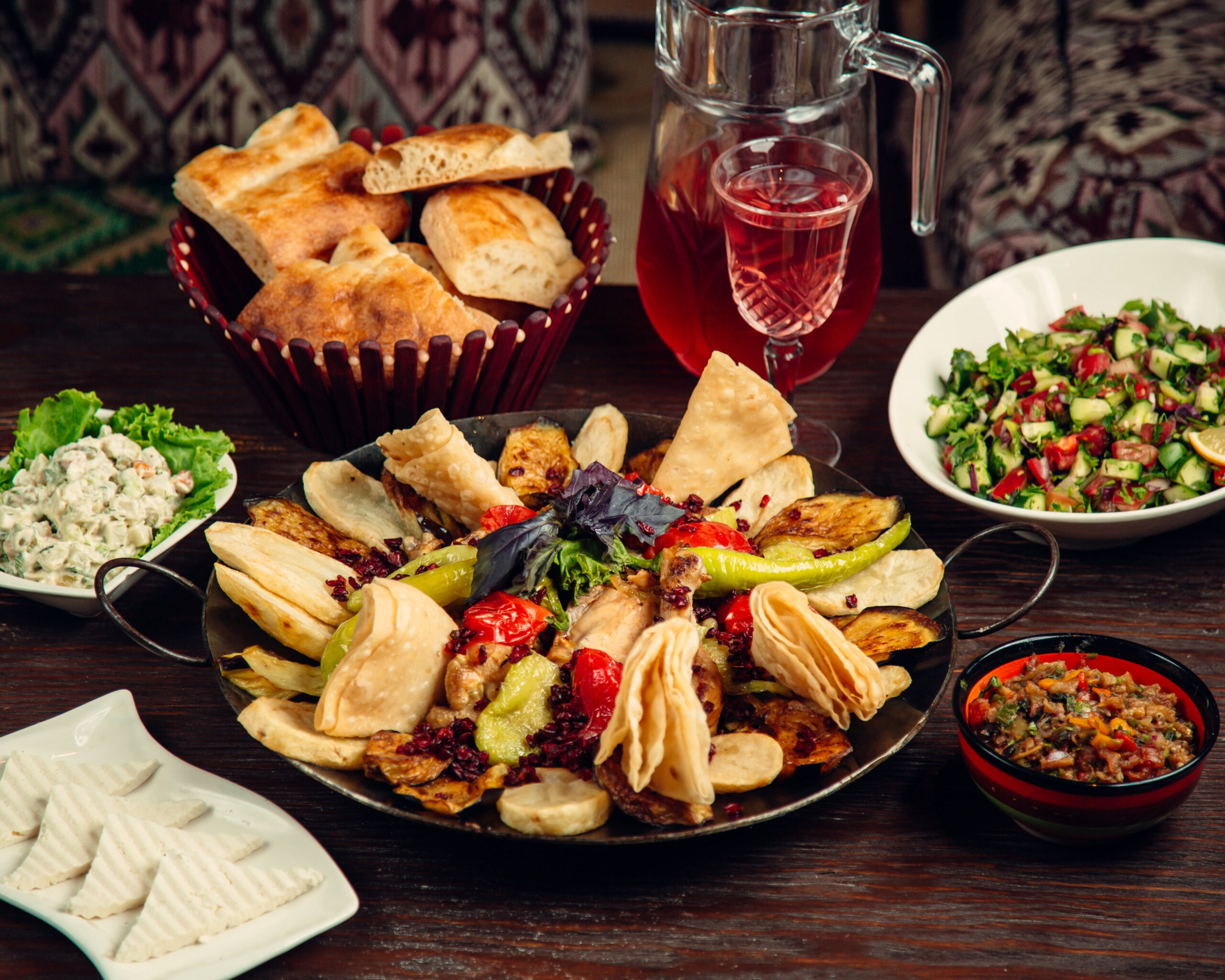 sadj in iron pot with various salads